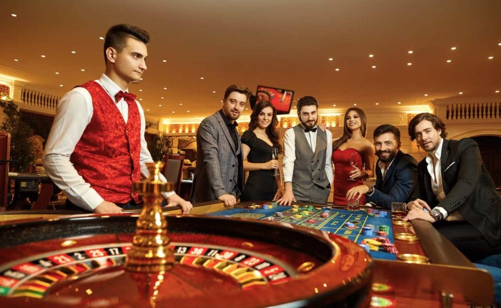 Group of friends playing roulette dressed up in suits and dresses