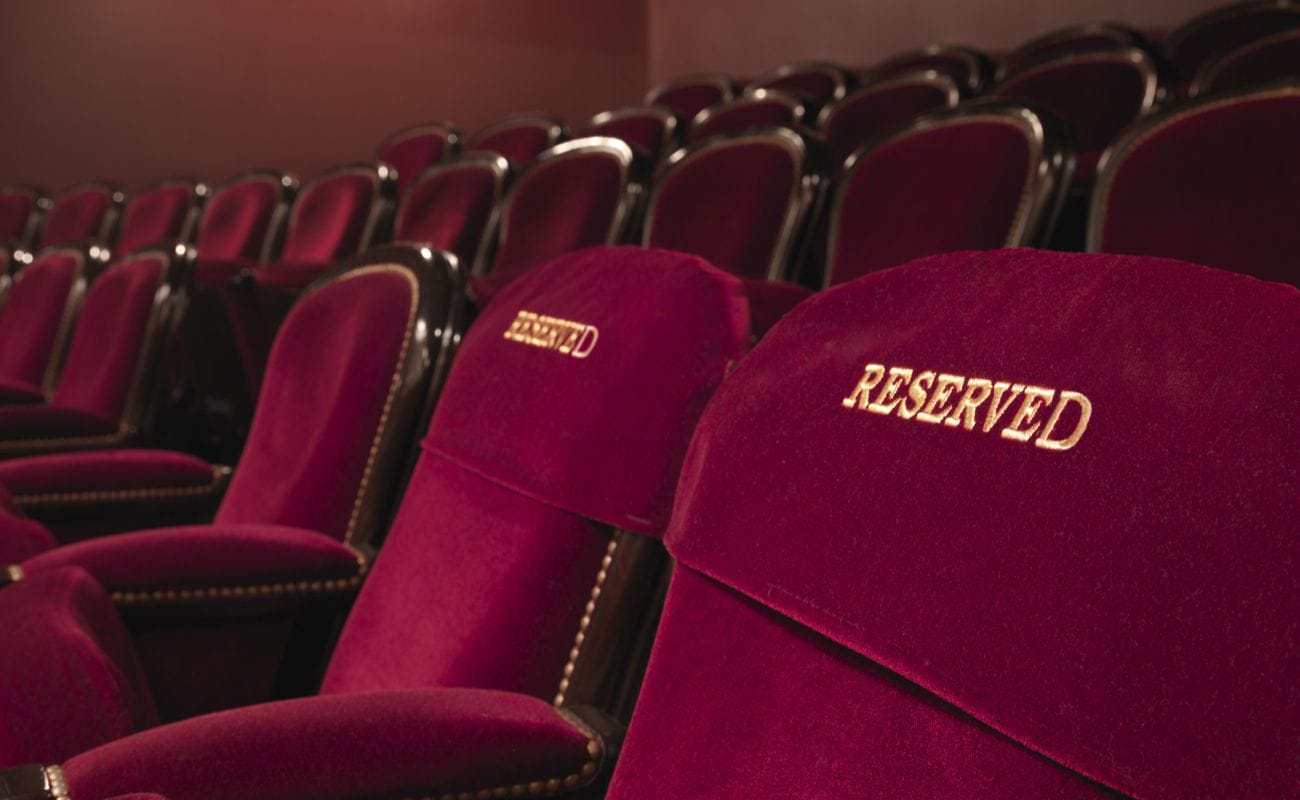 Red velvet front row seats with 2 seats embroidered with the word reserved