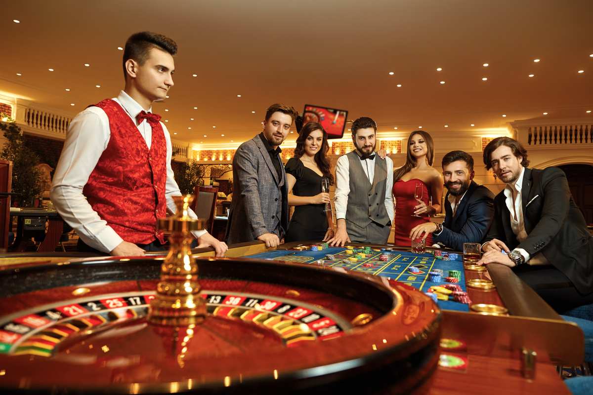 Group of friends playing roulette dressed up in suits and dresses