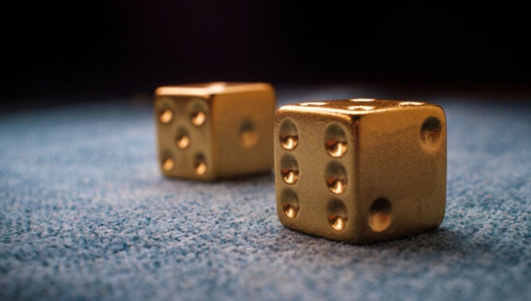 Two golden dices on the playtable