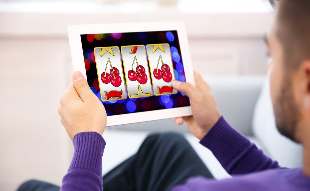 Man using tablet for playing online casino game at home