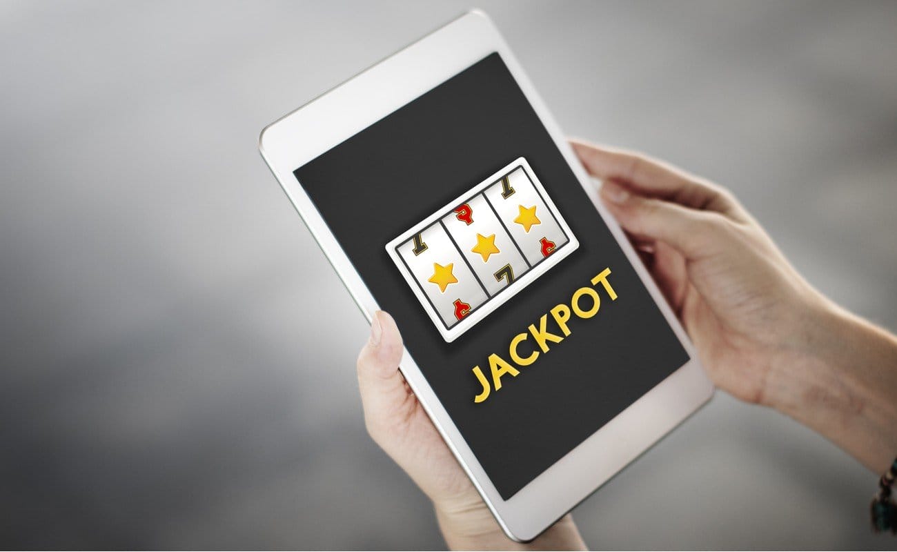 Man on tablet playing online slots