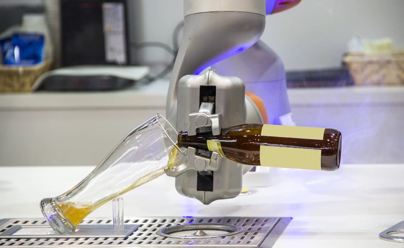 Robotic bartender pouring beer into a glass