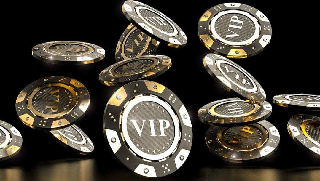 Casino chips with the word “VIP”, seen falling down as if scattered.