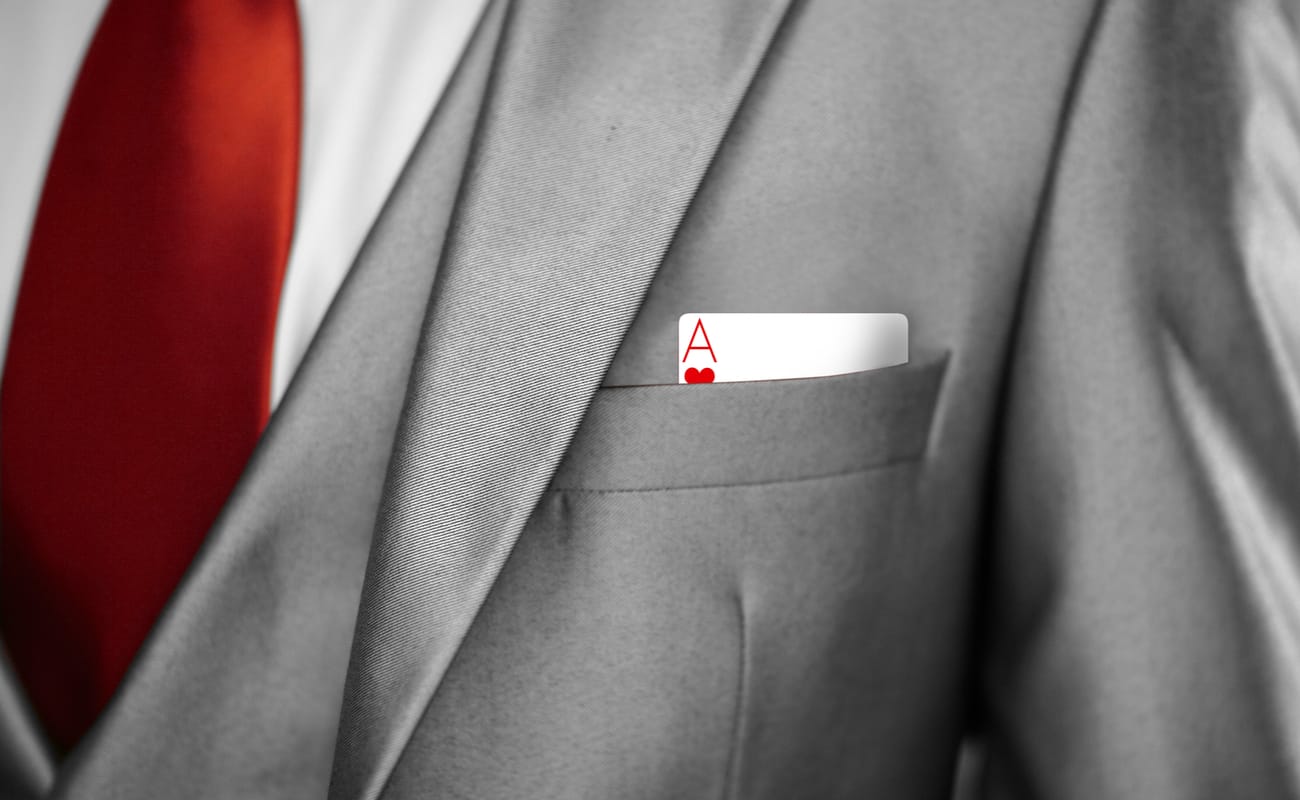 An ace card sticking out a business jacket pocket.