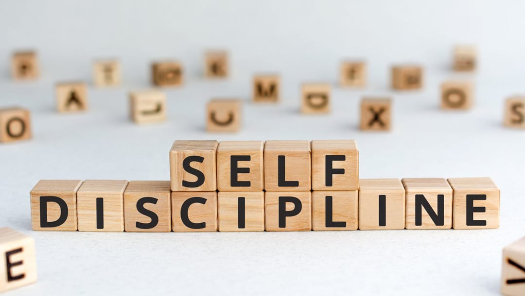 ‘Self-discipline’ spelled out in block letters on a white surface.