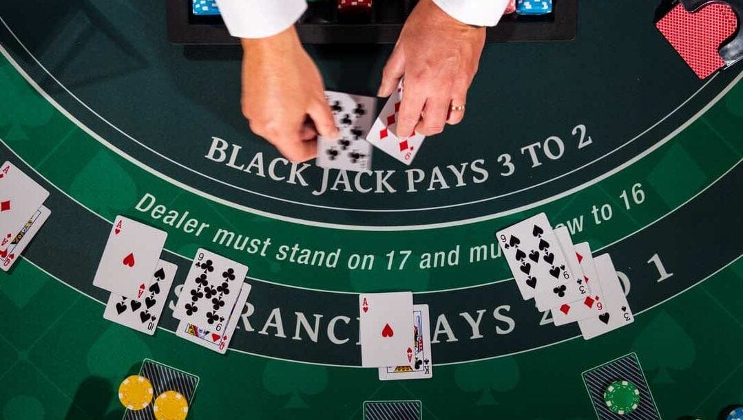 Top view of a blackjack casino table with cards and chips on the table.