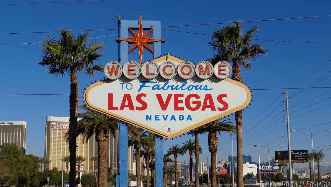 ‘Welcome to Fabulous Las Vegas Nevada’ sign with palm trees in the background.