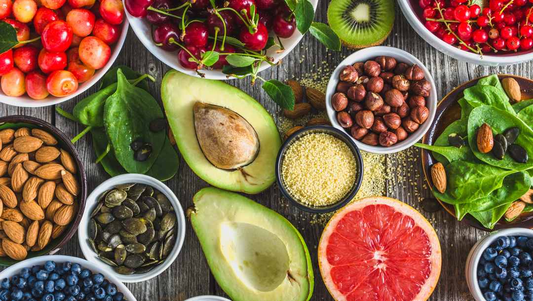 A variety of healthy ‘superfoods,’ including avocado, almonds, blueberries and cherries.