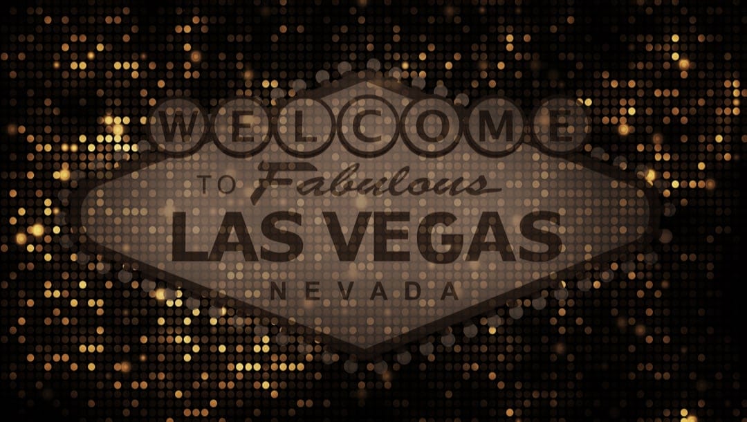 A brown ‘Welcome to Fabulous Las Vegas Nevada’ sign with gold lights in the background.