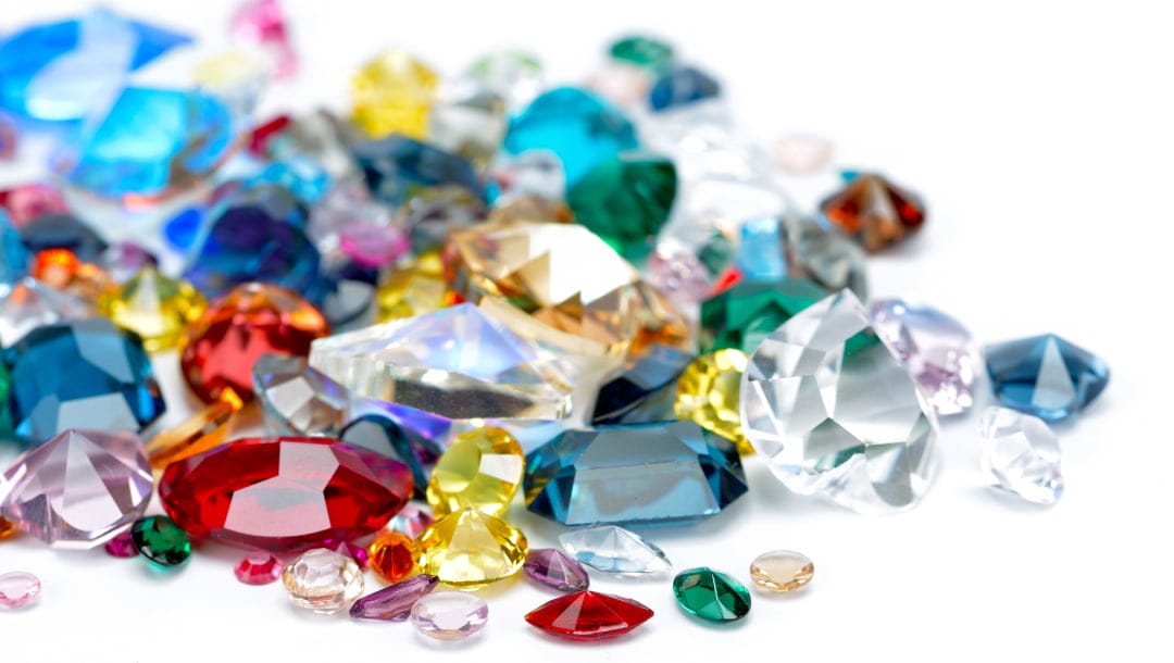 Various gems of different types and colors, including rubies, diamonds, sapphires, and emeralds.