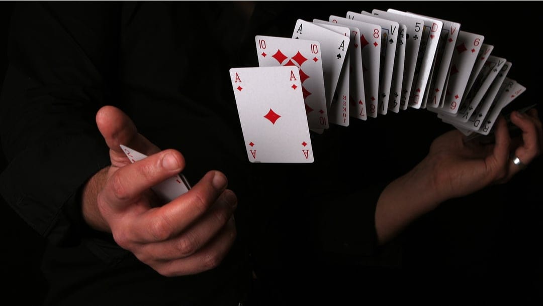 Close-up of hands shuffling a deck of cards.