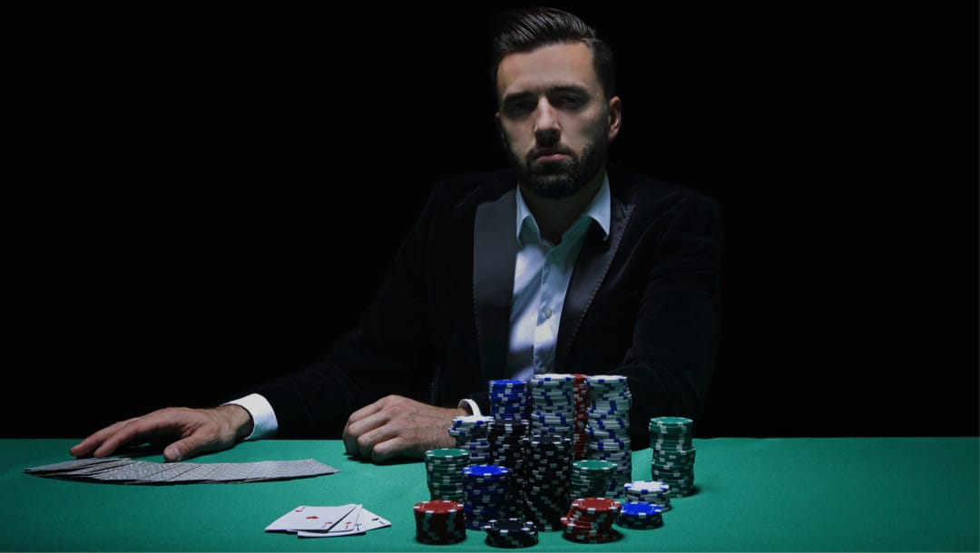A poker player with cards and casino chips.