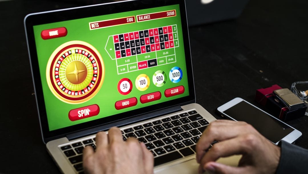 A person playing online roulette on a laptop.
