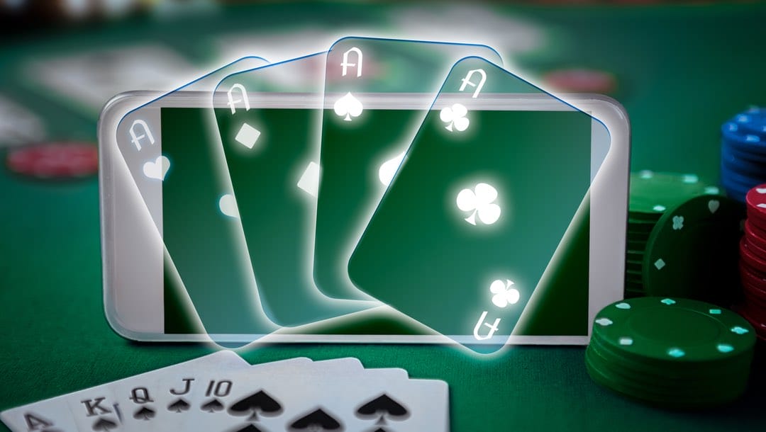 Four transparent aces on a smartphone surrounded by playing cards and casino chips.