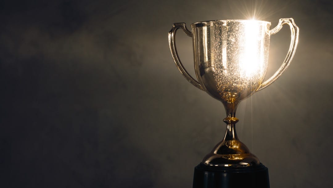 A glittering trophy on a dark and smokey background.