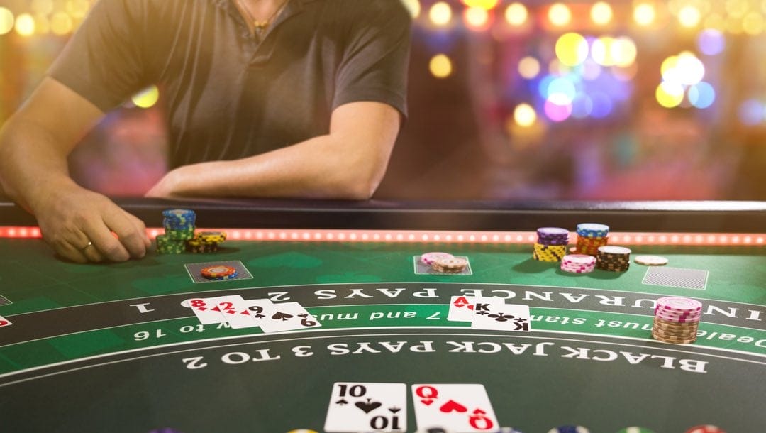 A player sits at a blackjack table.