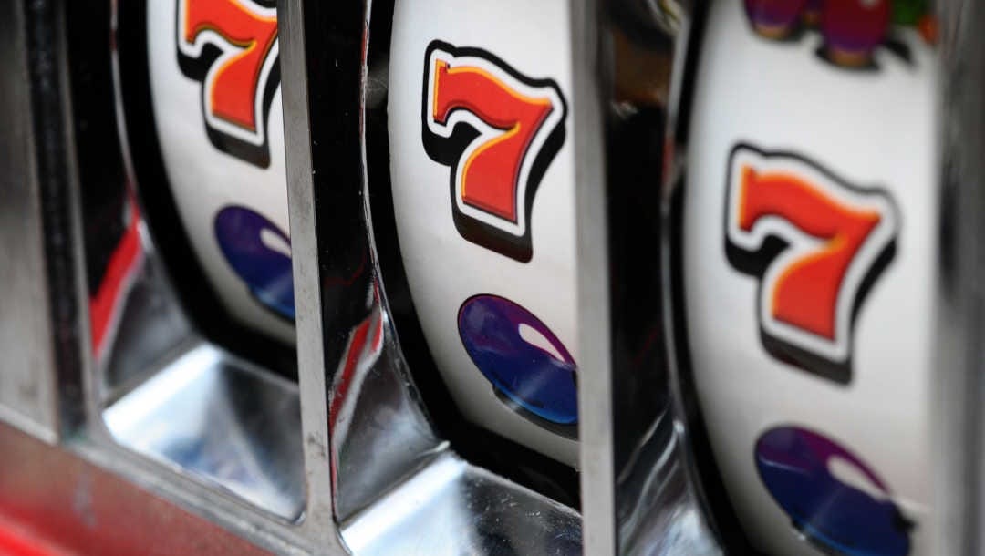 A classic three-reel slot machine showing three 7s.
