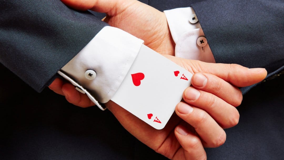 A man wearing a suit with an ace up his sleeve.
