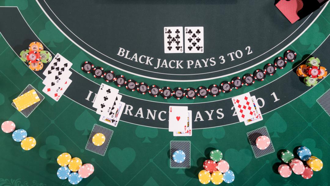 An overhead view of a blackjack game.