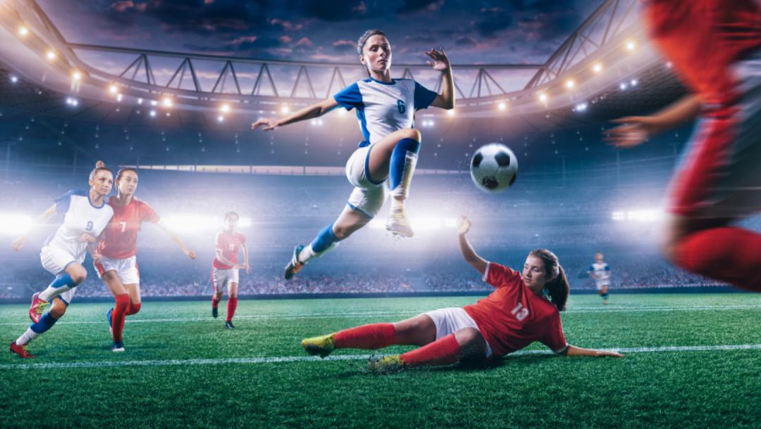 A soccer player leaps over an opponent attempting to perform a slide tackle on her.