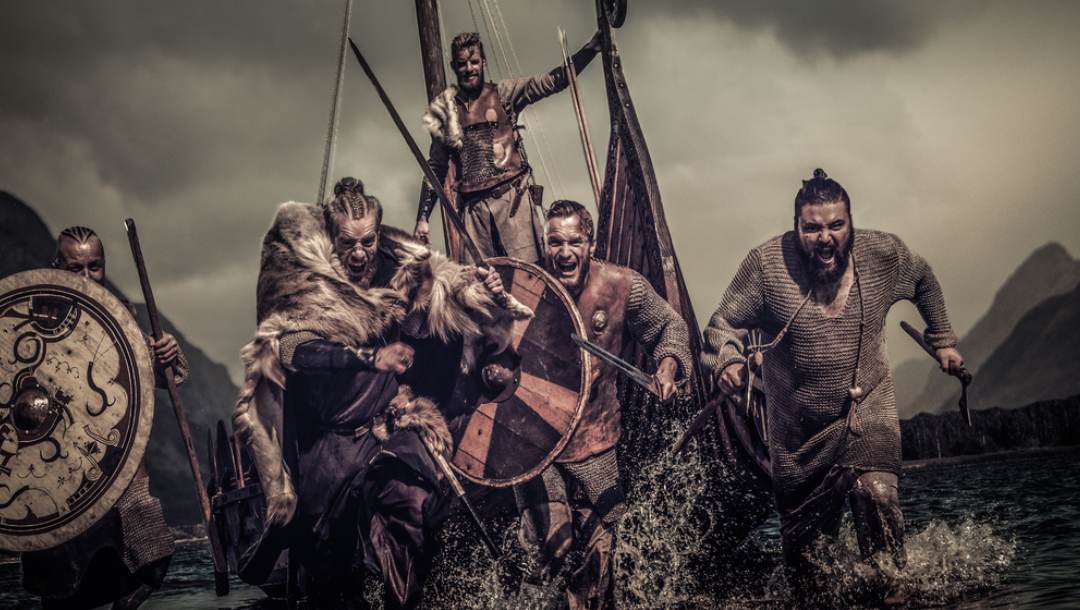 Vikings disembark their ship and charge into battle.