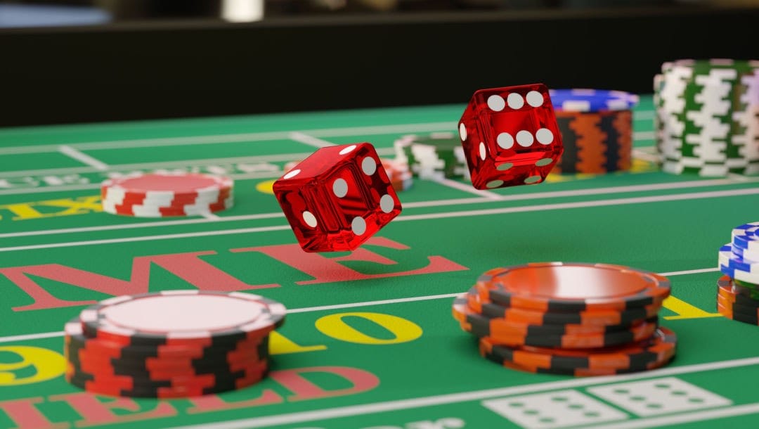 Close-up of a pair of dice rolling down a craps table.