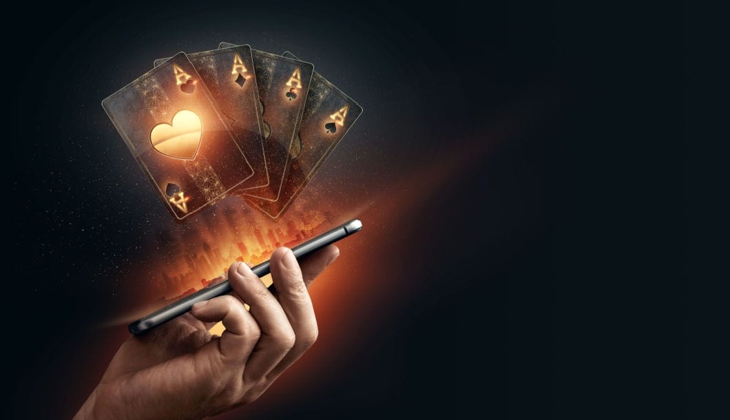 3d illustration of virtual playing cards featured above a smartphone.