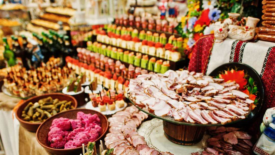 A large buffet table filled with a variety of deli meats and other dishes.