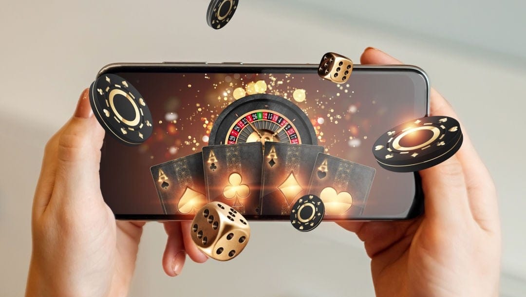 A smartphone featuring casino elements, including a roulette wheel, playing cards, chips and dice.
