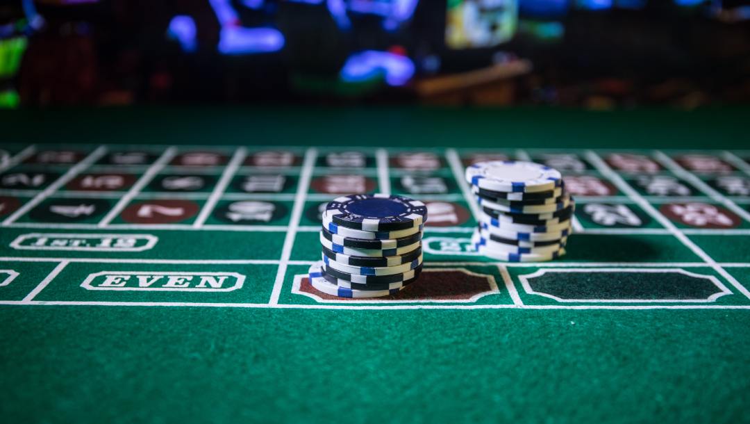 Casino chips on a poker table.