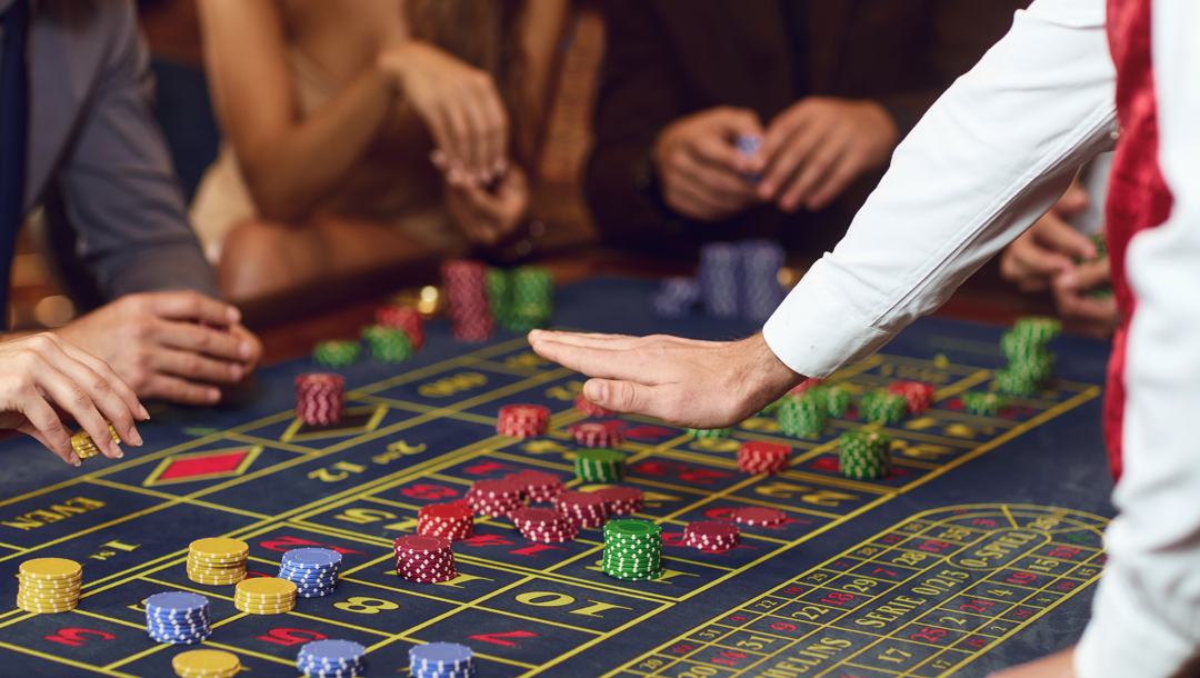 A dealer closing bets in a roulette game.