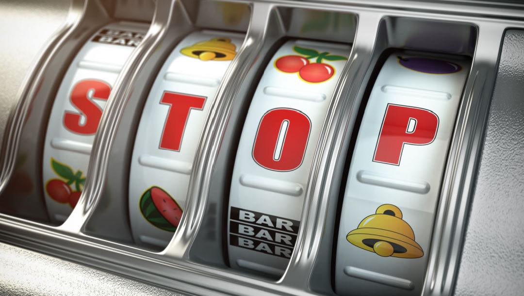 A traditional slot machine featuring the word “STOP”.