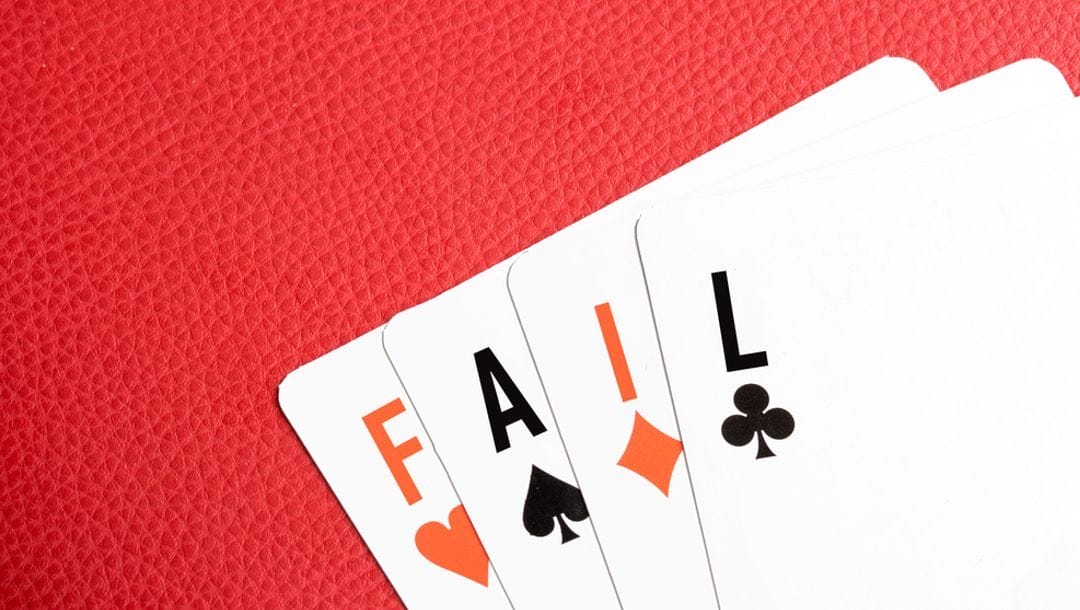 “FAIL” written on playing cards.