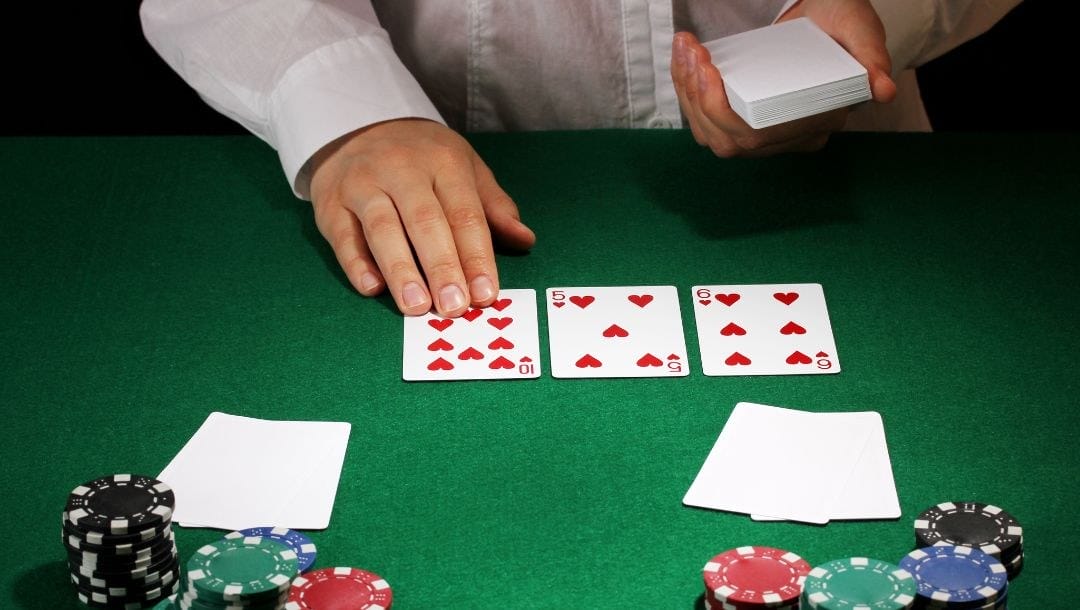 Croupier dealing cards at a poker table