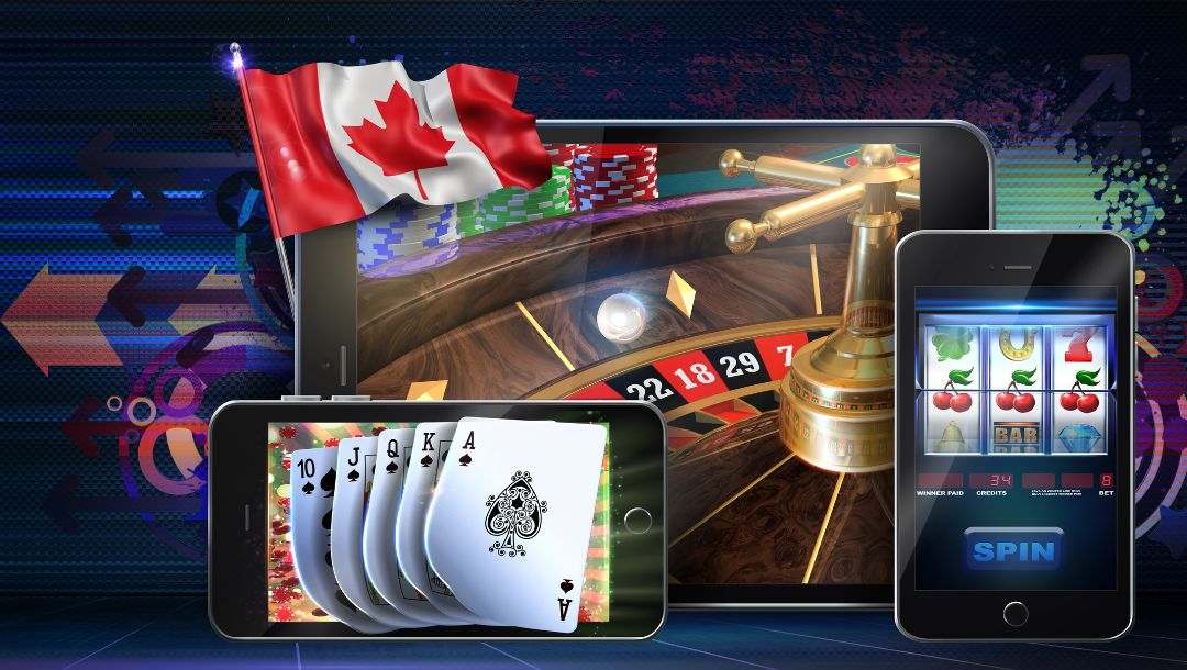 Concept image of online casino games in Canada featuring mobile devices displaying playing cards and slot machine as well as an electronic tablet displaying a roulette table with a canadian flag flying beside it