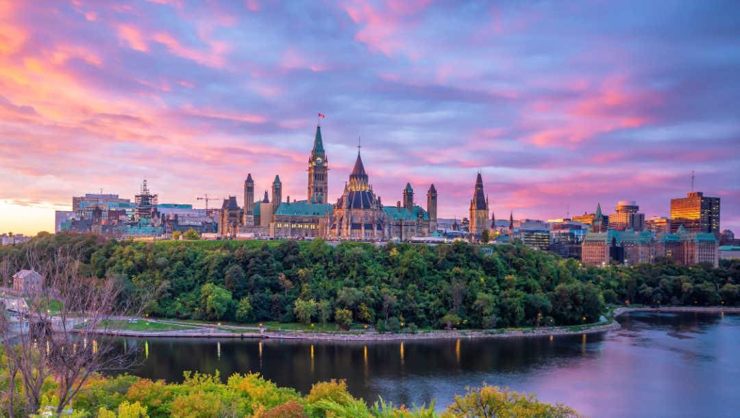 A view of Parliament Hill, Ottawa, at sunset.