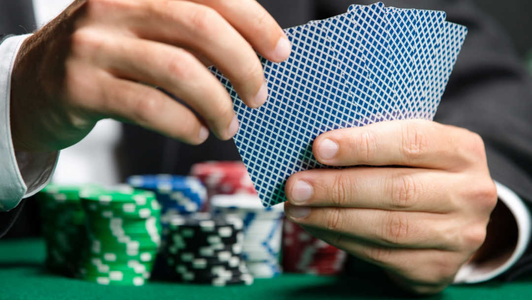 A player about to select a card in a poker game