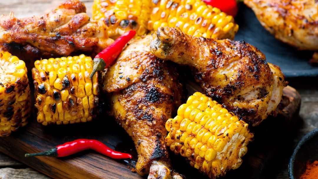 Grilled cajun chicken with corn and chilis.