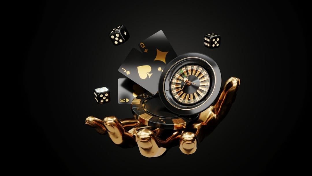 A golden hand holding black and gold casino elements including a chip, roulette wheel, playing cards and dice.