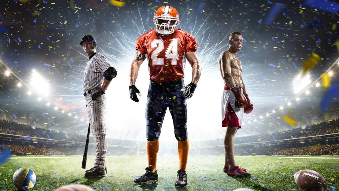 A baseball player, a football player and a boxer stand on a field in a stadium. A bright light shines behind them.