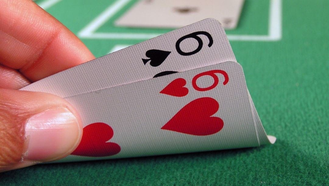 Header image, pocket sixes on a green felt poker table
