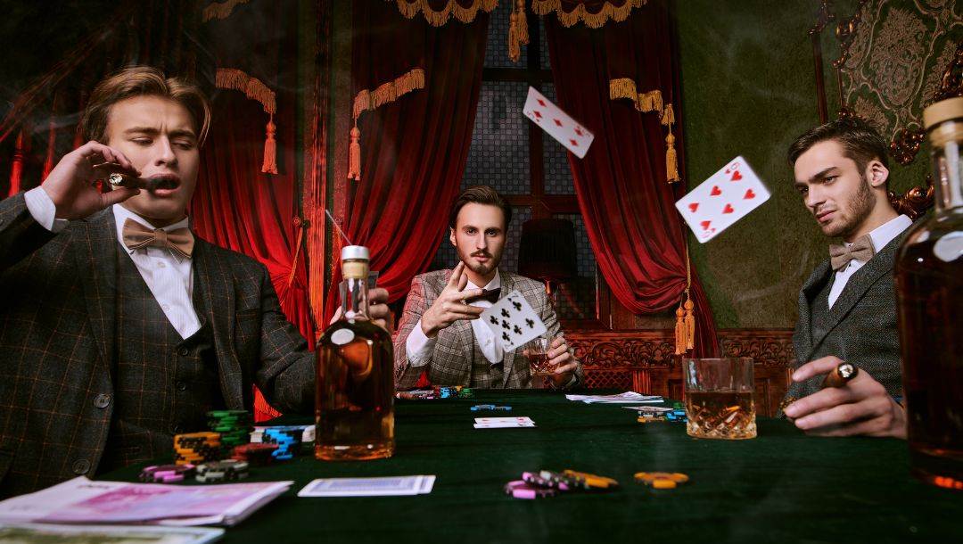 three well dressed men sitting around a green felt poker table smoking cigars, drinking and playing poker, playing cards are flying in the air