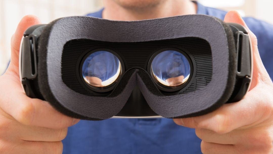 a man holding a Virtual Reality headset
