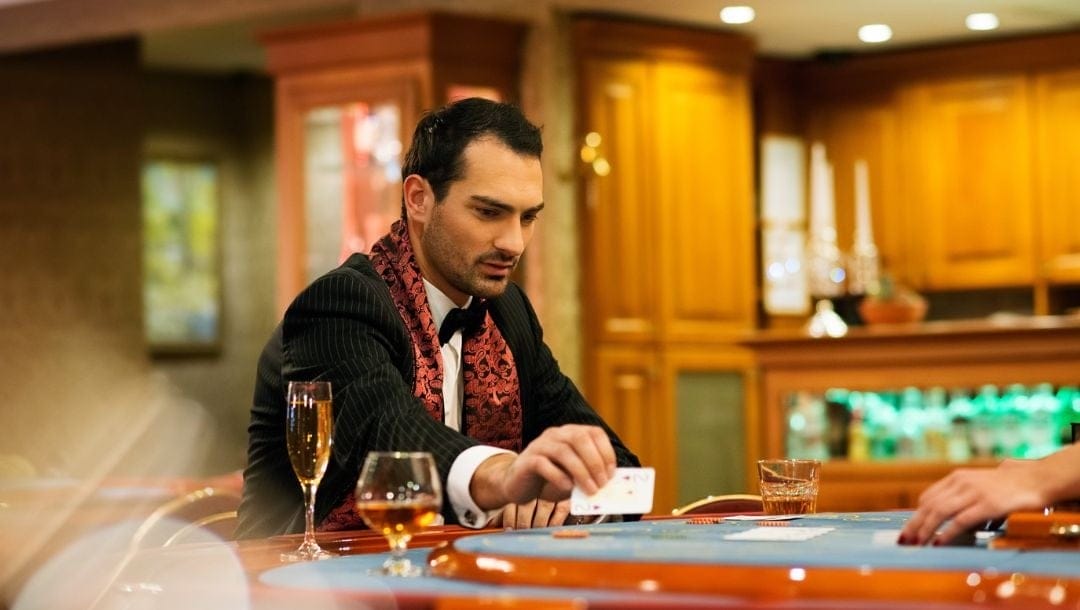 a wealthy well-dressed man in a suit sitting at a poker table playing poker in a casino