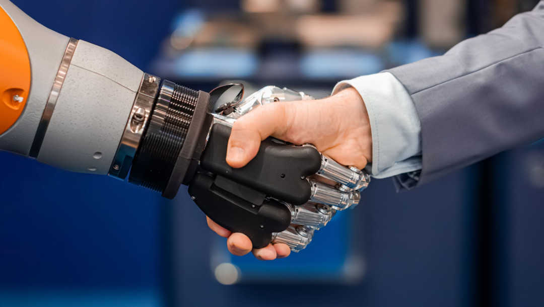 A human shaking hands with a robot.