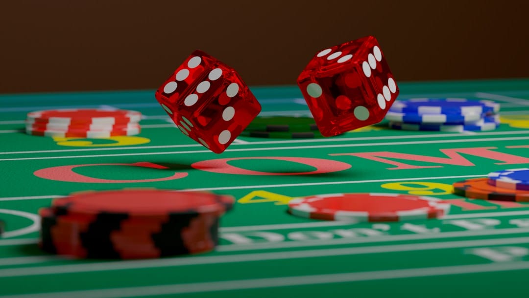 A close-up of dice rolling on a craps table between casino chips.