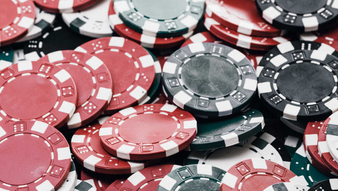A pile of poker chips in different colors,