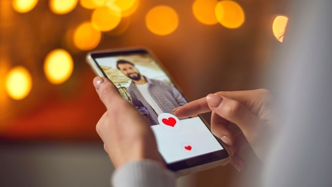 A woman viewing a man's profile on a dating app.
