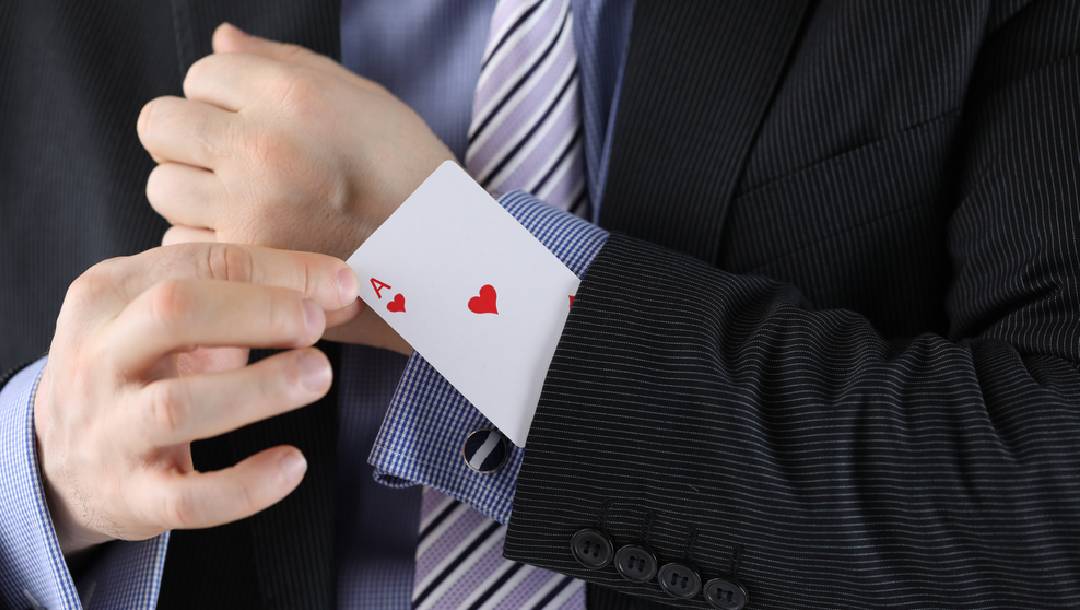 A man pulling an ace card out of his sleeve